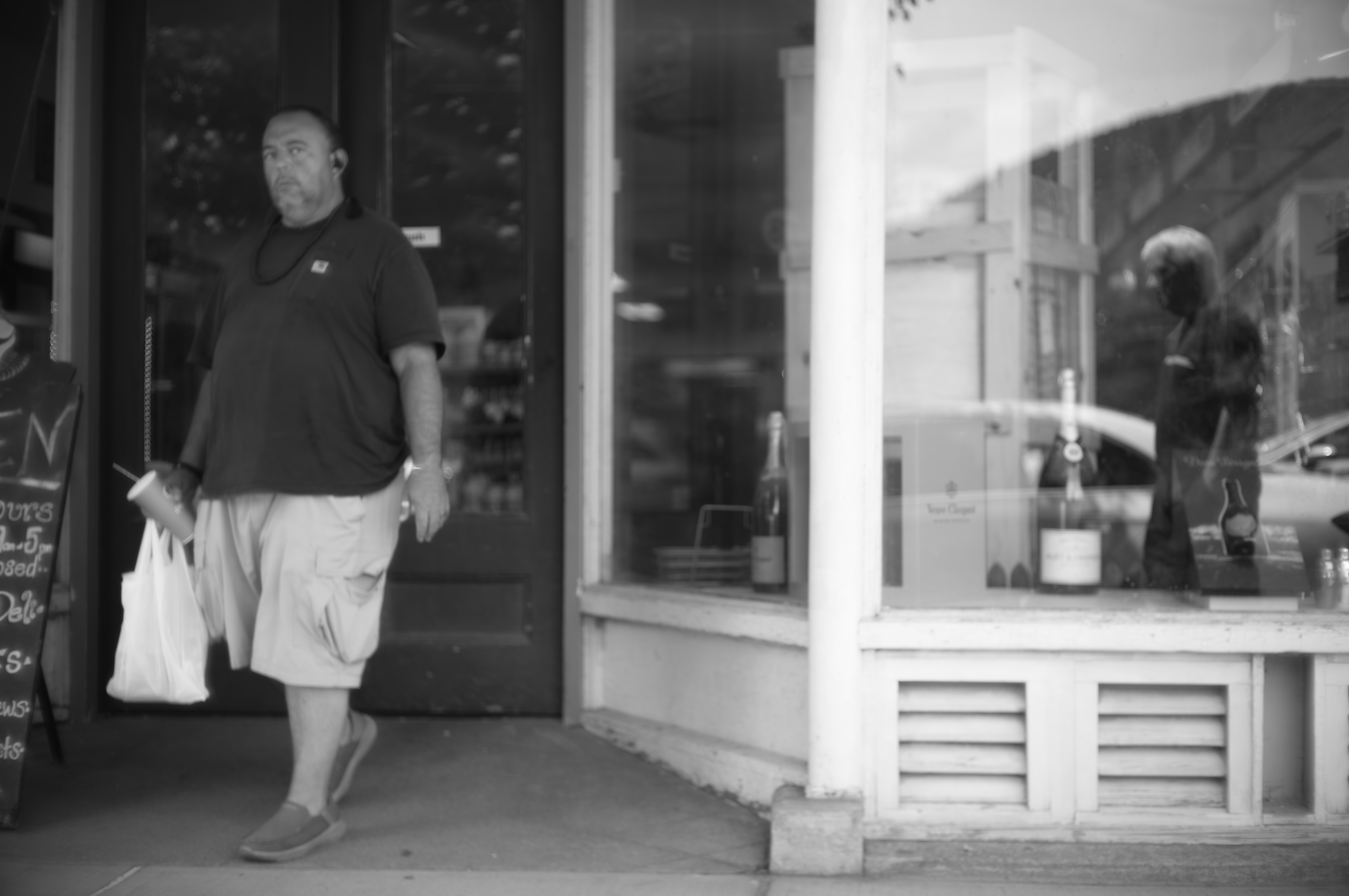 Urban street scene with architectural elements and human presence, captured in dramatic light and shadow.